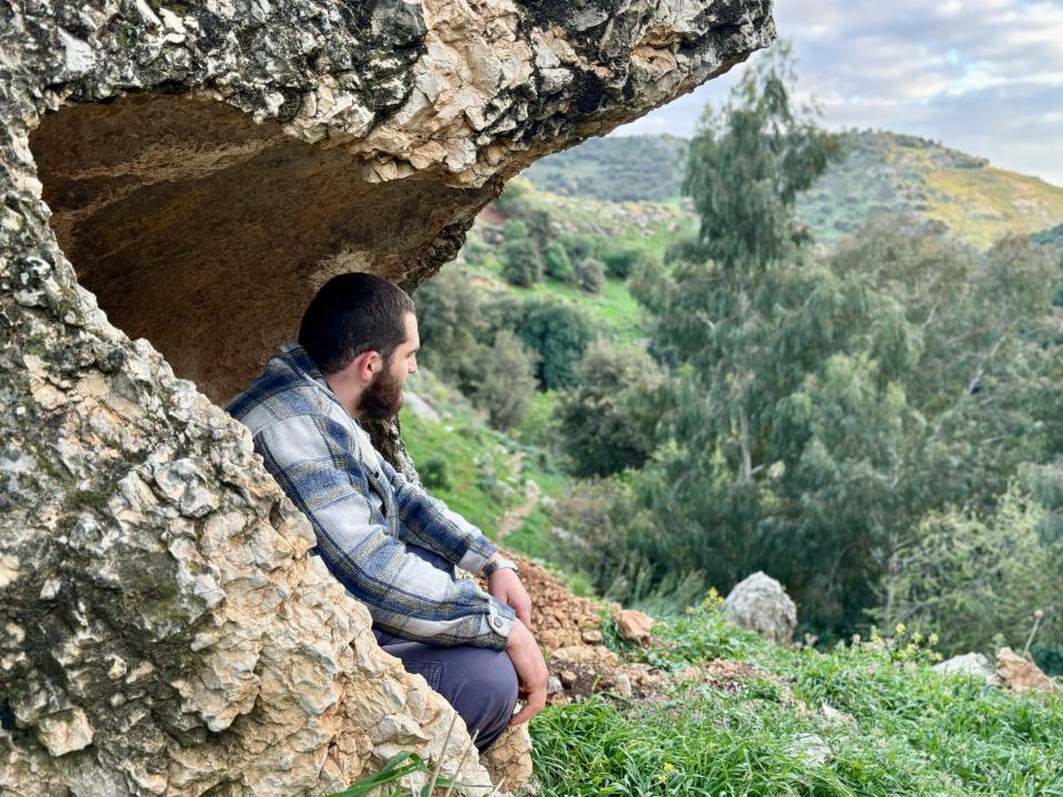 Man sitting in rocky landscape